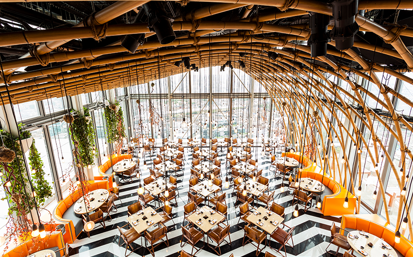 11 Rooftop Bars & Restaurants in the City of London - SushiSamba 11 Rooftop Bars & Restaurants in the City of London - SushiSamba - high ceiling space, zigzag black and white tiled floor with lots of dinnig tables