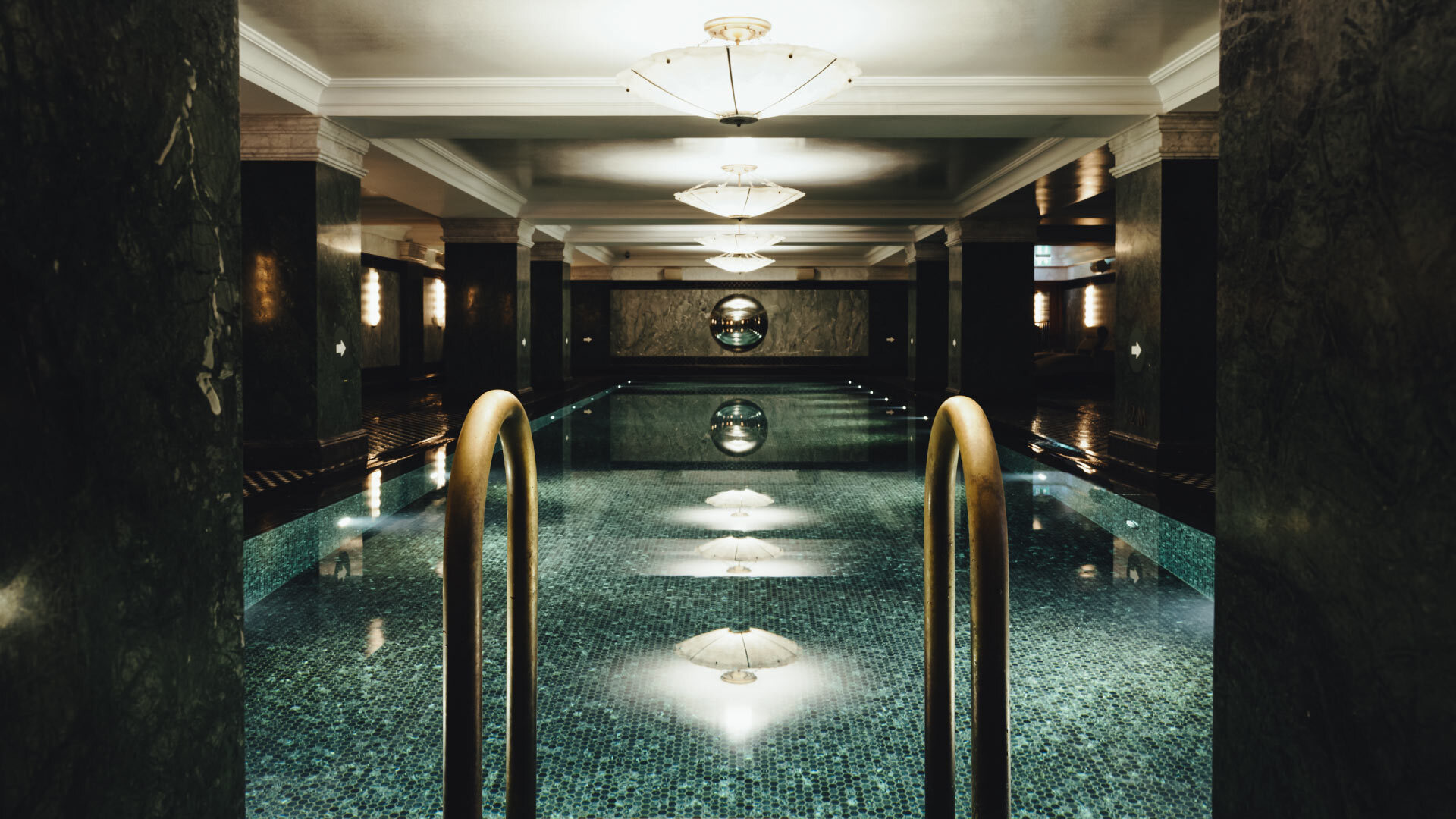 5 best Spas in the City of London - The Ned Spa 5 best Spas in the City of London - The Ned Spa - indoor pool, long tiled pool, black marble pillars surrounding it