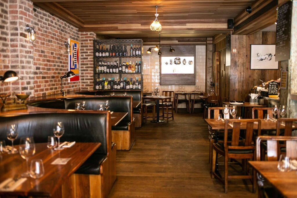 9 Best Brunch Spots in the City of London - Jose Pizarro 9 Best Brunch Spots in the City of London - Jose Pizarro - bare brick walls, leather booth seating and racks of wine