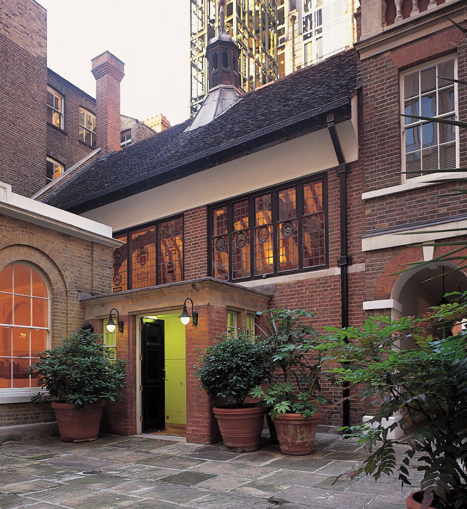 Gresham College - brick building - entrance surrounded by potted plants