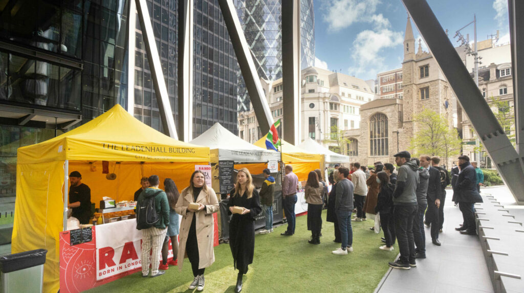 People visiting Street Market stalls underneath the Leadenhall Building.