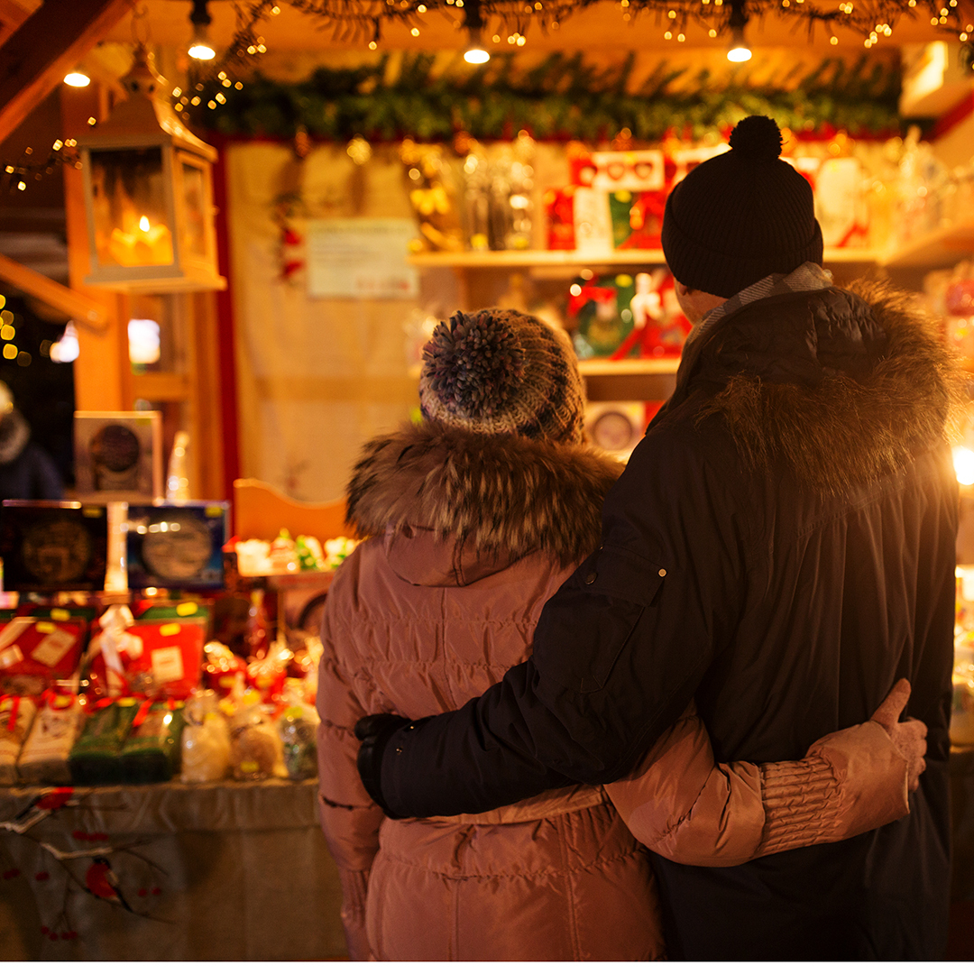 Senior couple hugging at Christmas market
