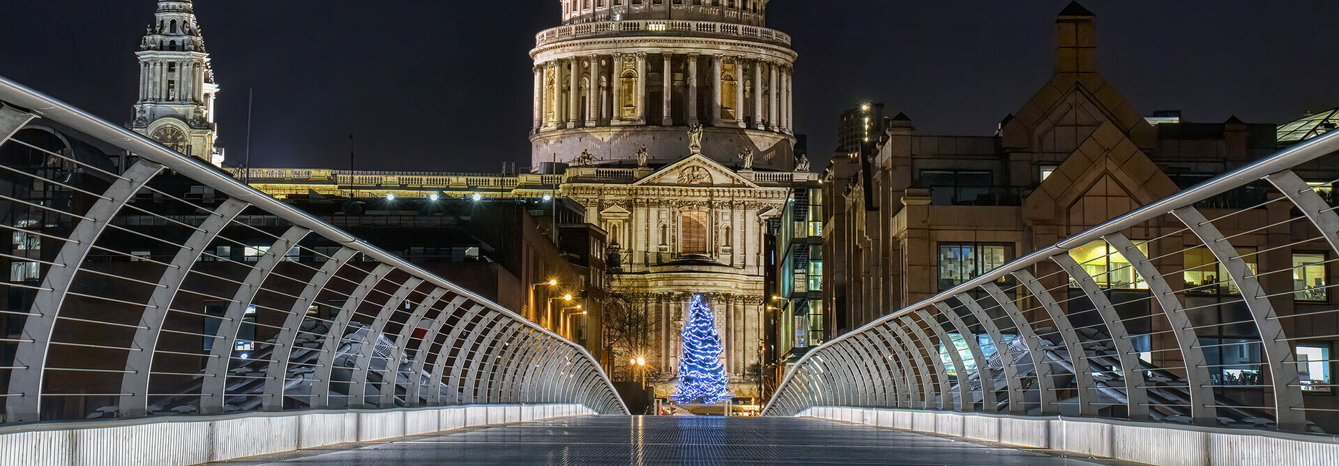 Illuminated Christmas Tree at the end of a bridge with St Paul's Cathedral behind