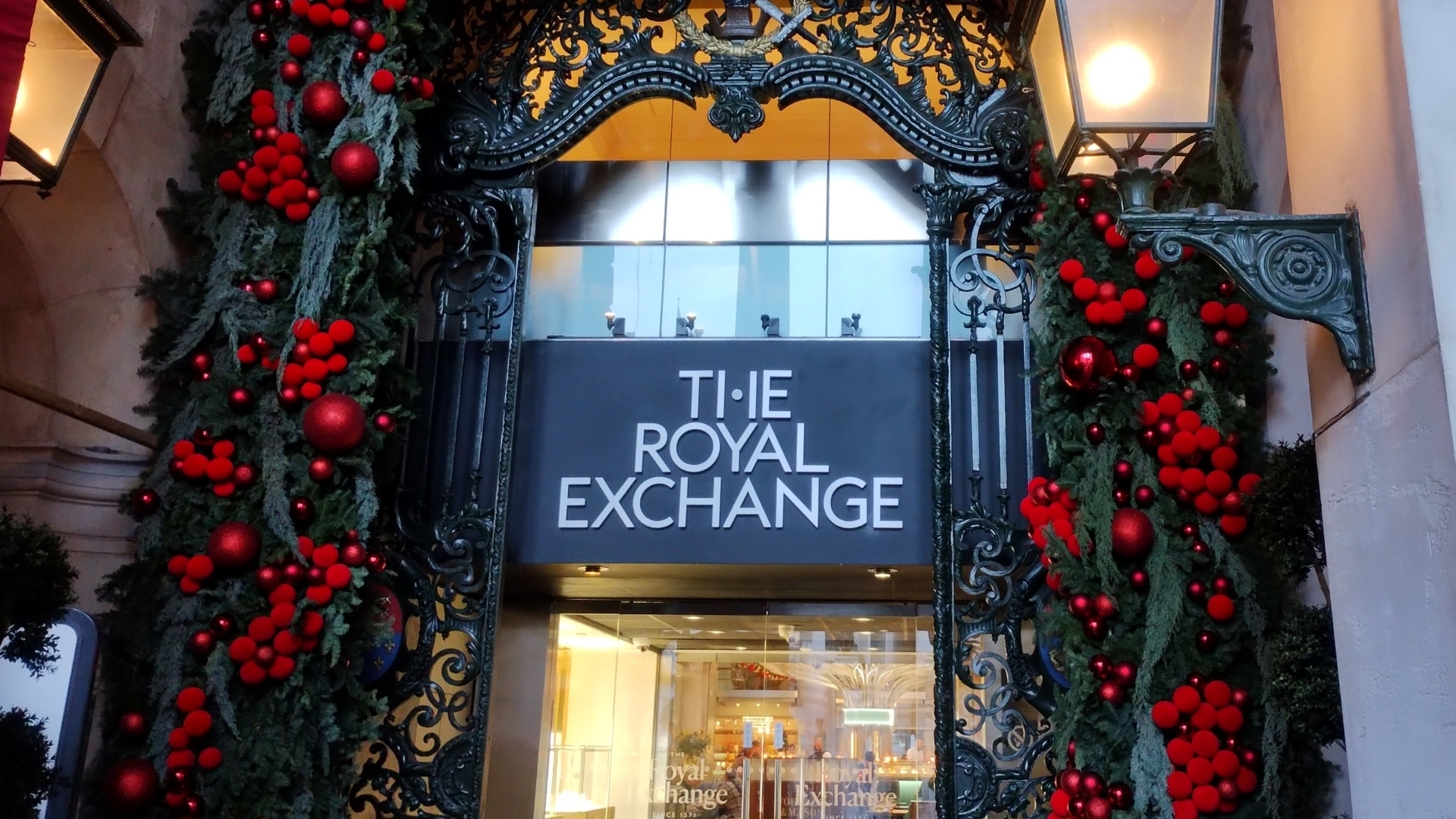 Royal Exchange entrance with red and green festive foliage
