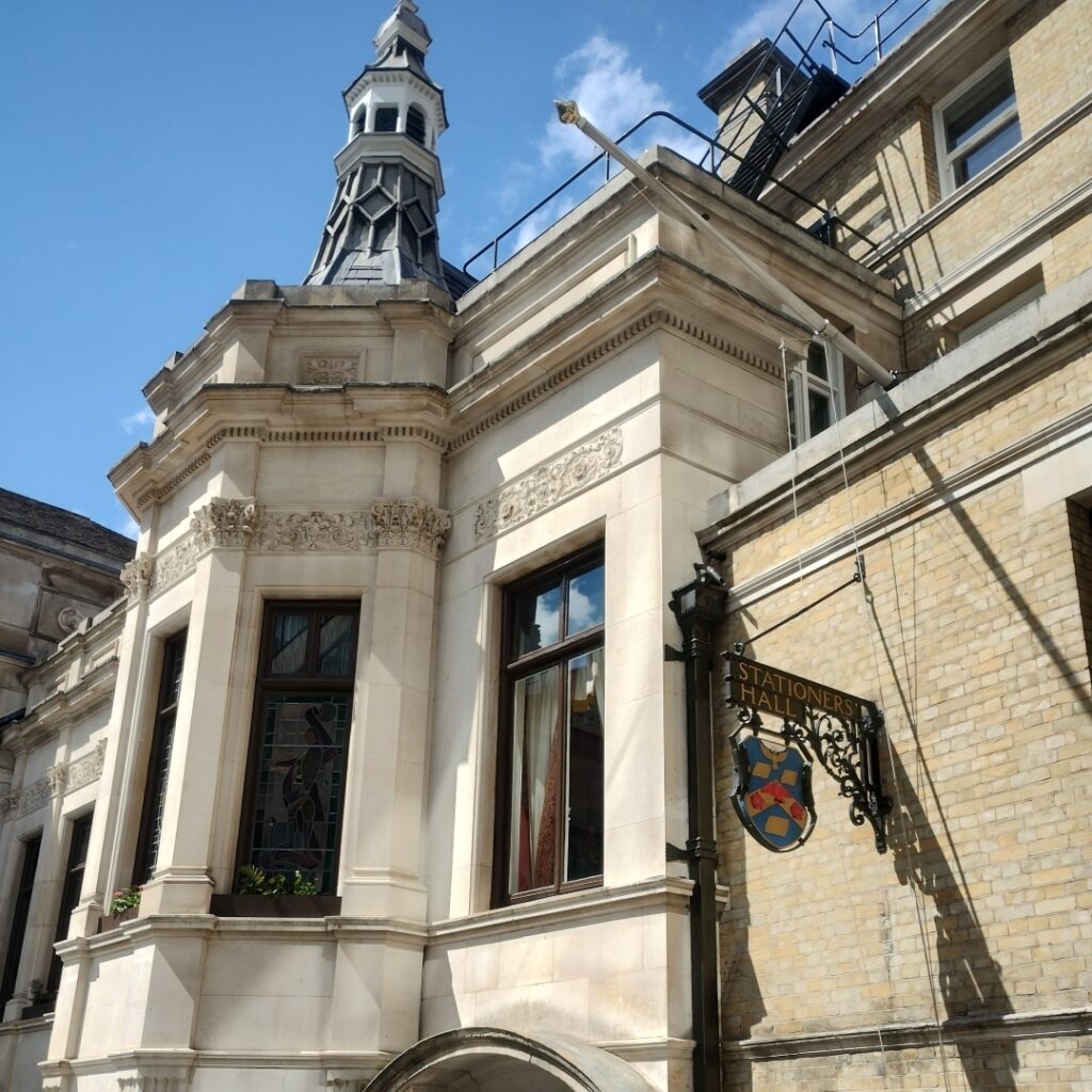 Exterior of Stationers' Hall - sign saying Stationers' Hall, and stained glass window.
