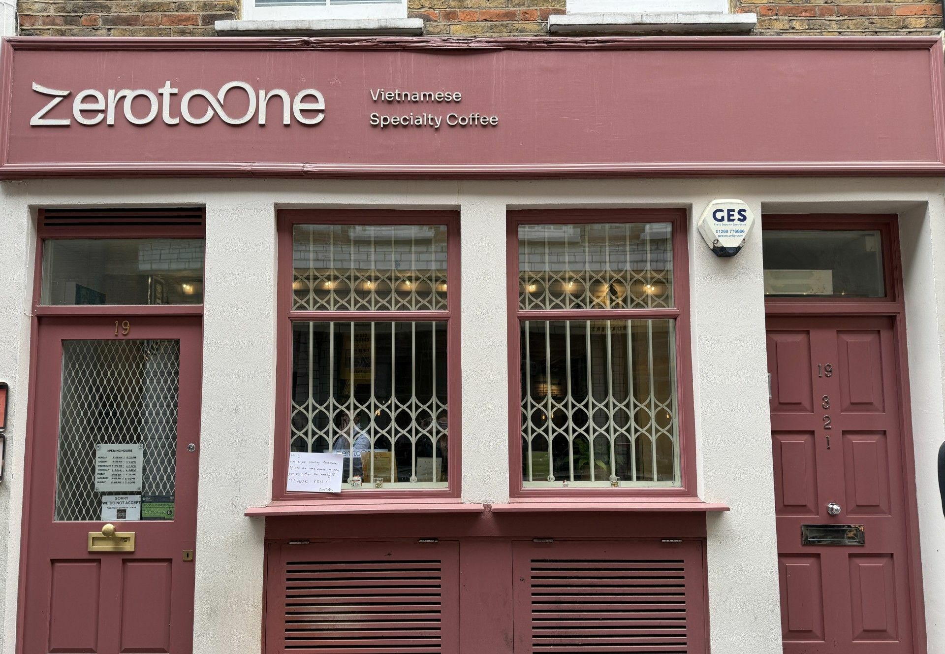 The red front of Zero to One coffee with the logo above the door on the left hand side.