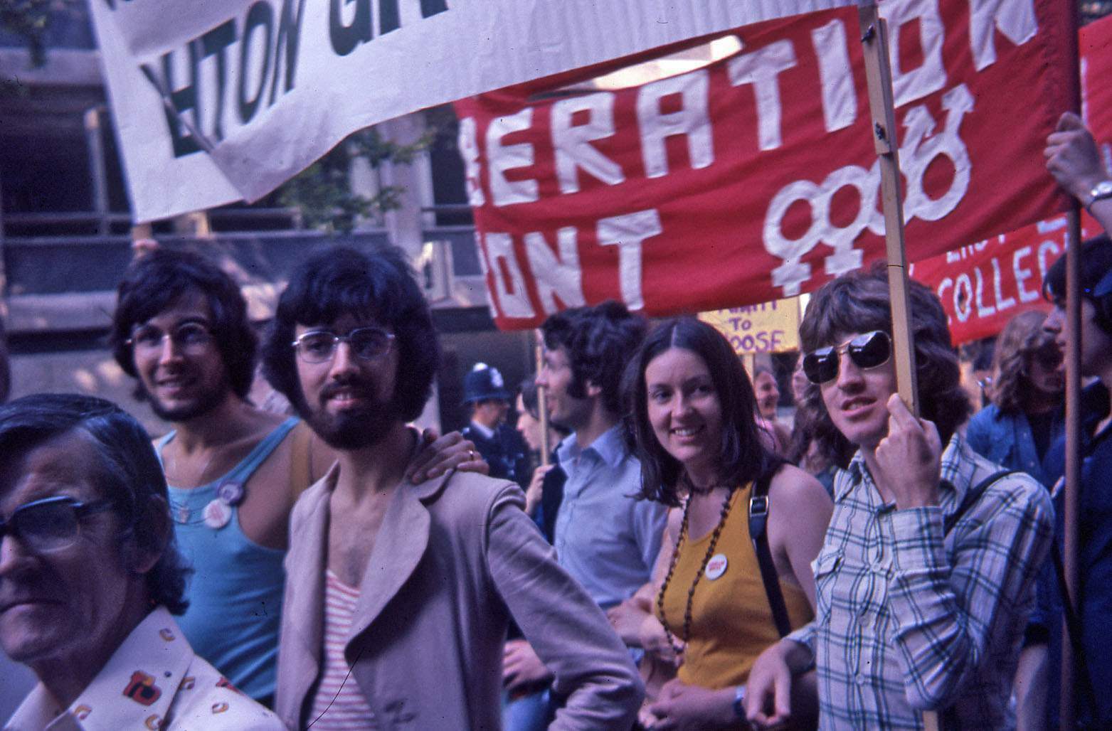 An archival image of a group of people marching, holding up placards