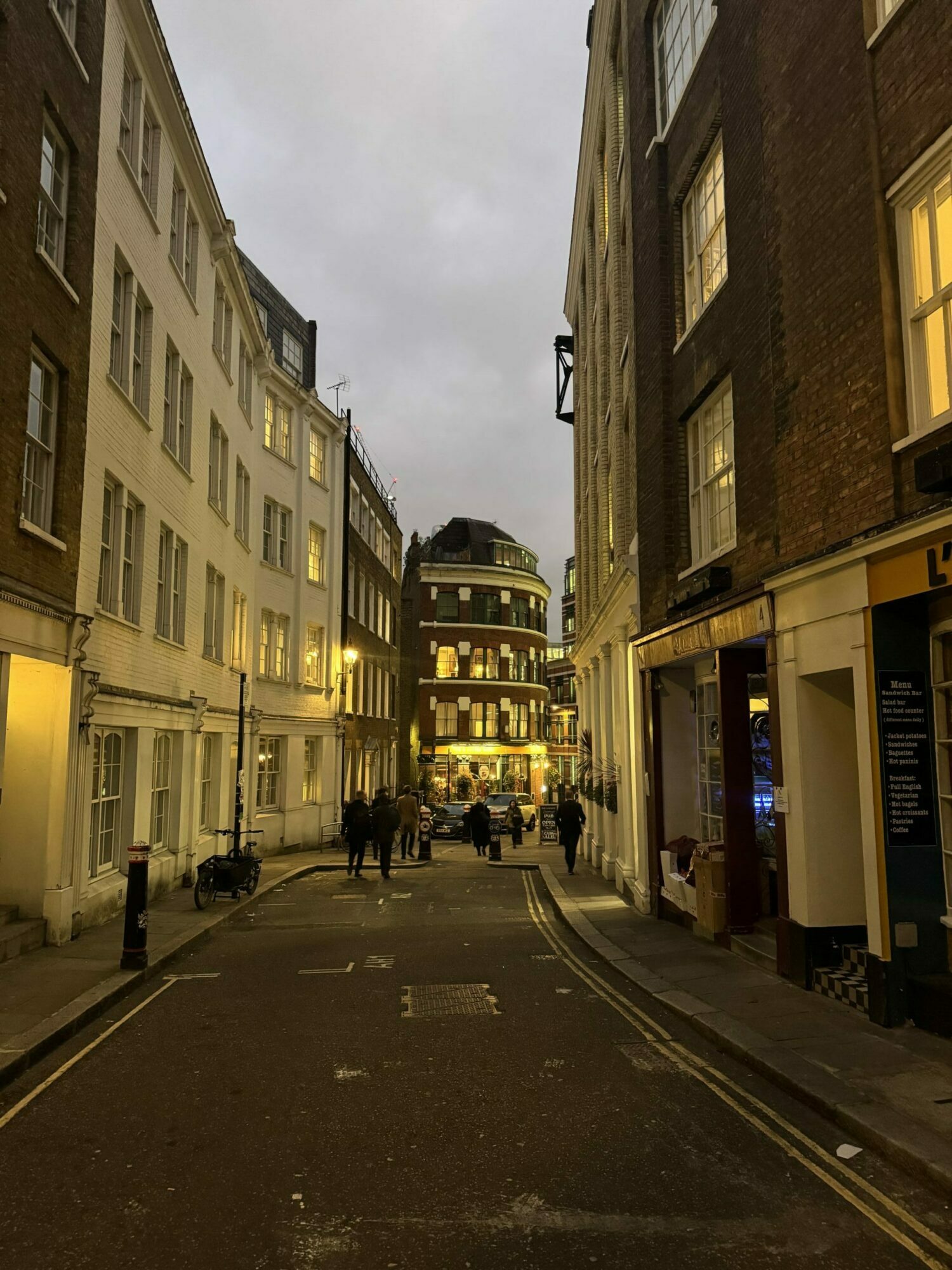An image of a dark lane in the City with the Cockpit pub at the end