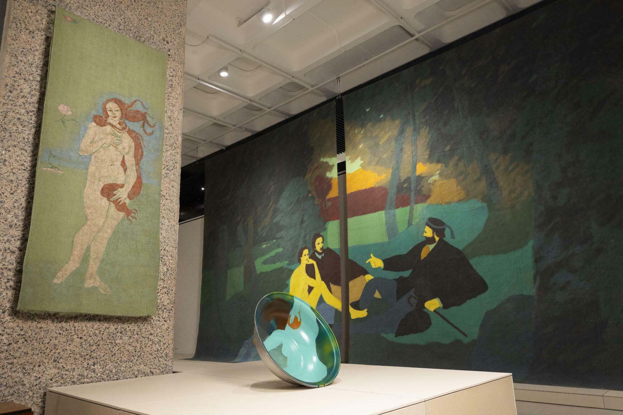 A view of paintings and sculptures installed for an exhibition, in a art gallery