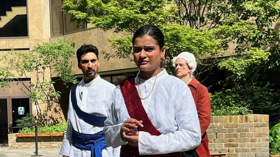 A group of actors performing a street play