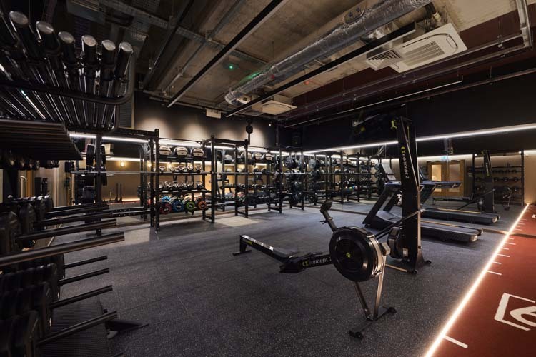 Image of a gym floor with lots of equipment with no one around