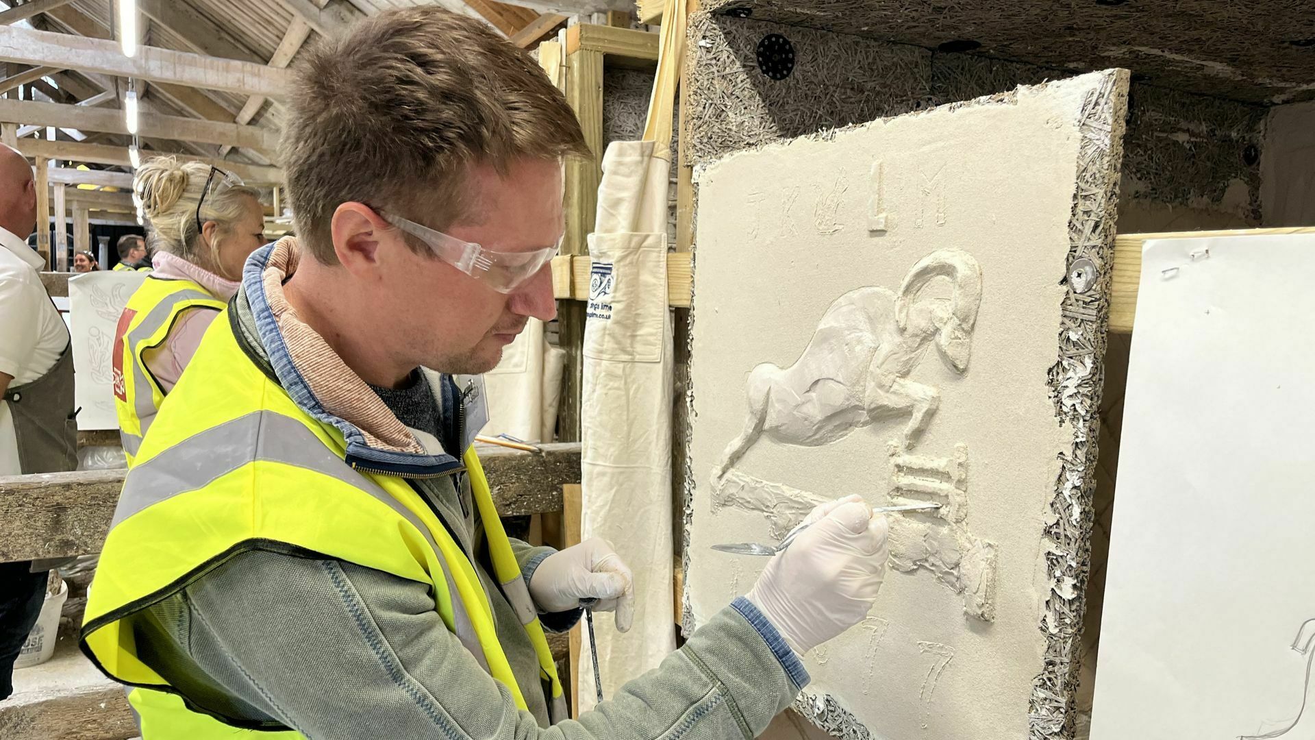 A person is demonstrating plastering skills
