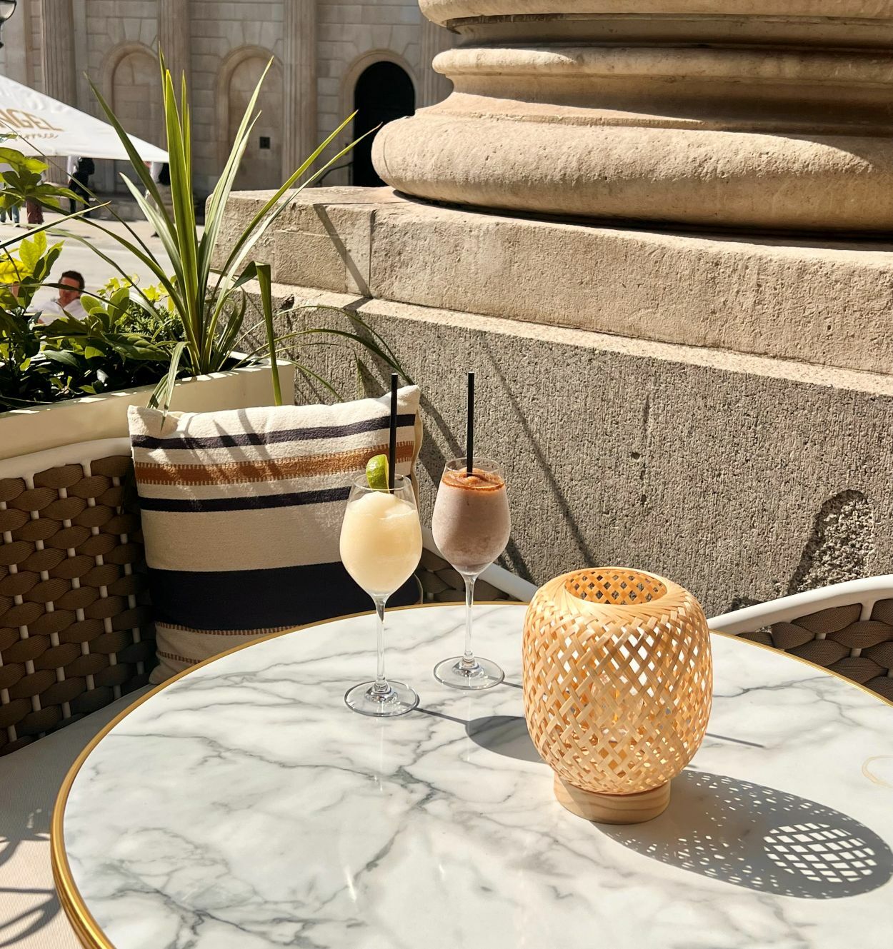 Image on a sunny terrace showing two frozen cocktails