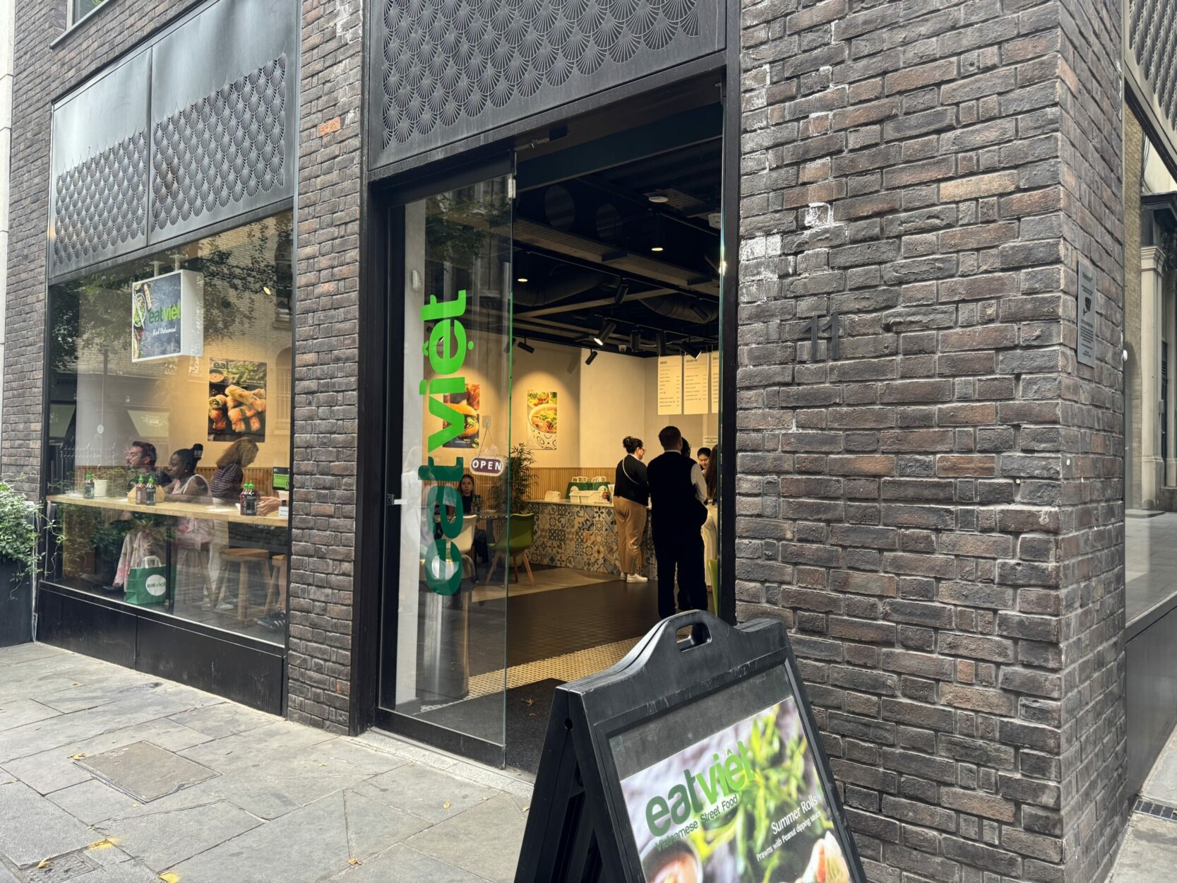 The front of EatViet with the logo across the door and an A board outside.
