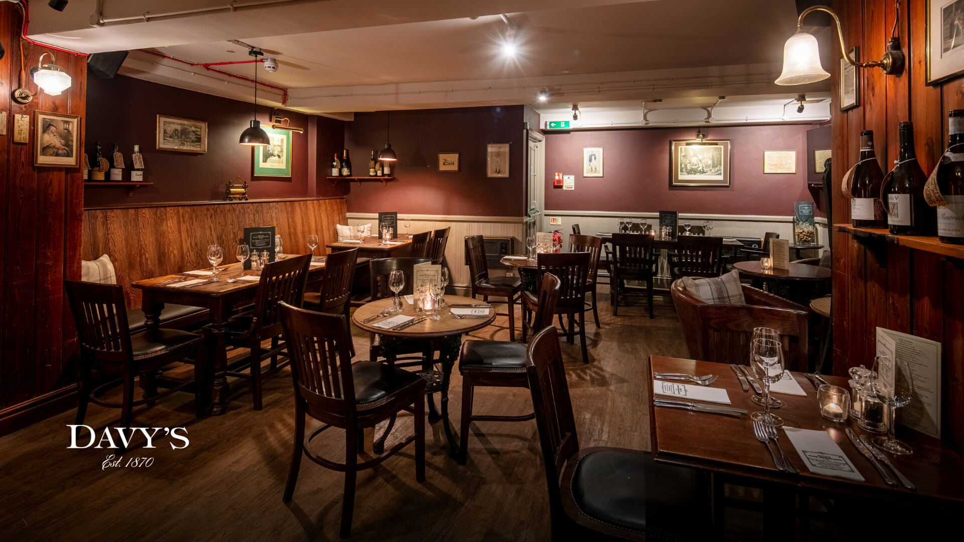 Inside of Grapeshots with an empty interior and tables set, there is wooden furnishings everywhere