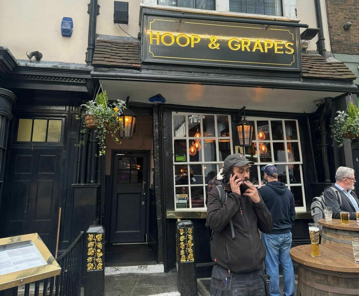 The front of the Hoop & Grapes Aldgate with people stood outside